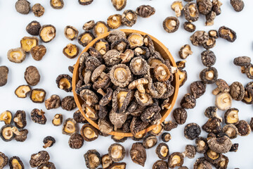 Dried small shiitake mushrooms on white background