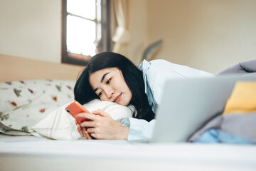 Young adult single woman using smartphone in the moring for social message app chat with friend