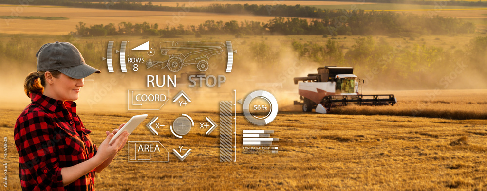 Fototapete remote control of an autonomous combine in the field. farmer with a digital tablet in the agricultur