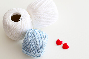 blue and white crochet yarn with red hearts