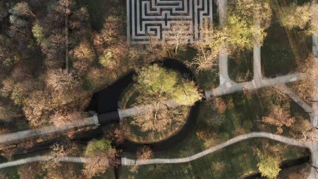 Drone shot of a garden labirynth hidden in a green park. Maze, mysterious place. Enigma, puzzle concept. Background aerial shot.