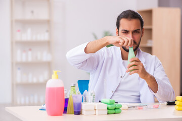 Young male chemist testing soap in the lab