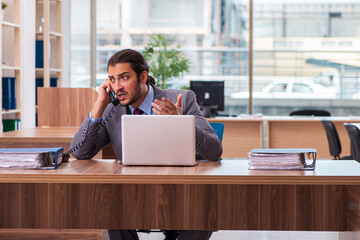 Young male employee working in the office