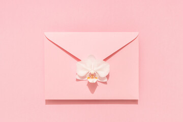 White Orchid flower on pink envelope. Congratulation mail for Womens, Mothers Day, Valentines,...