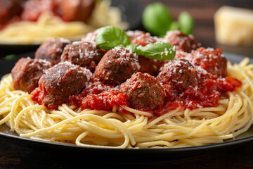 Vegetarian spaghetti with meat free, vegan meatballs in rich tomato sauce, grated cheese and basil leaves