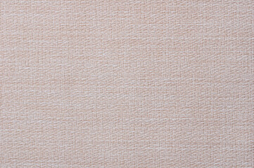 Close-up of a pattern of fabric imitating a natural canvas. Beige.