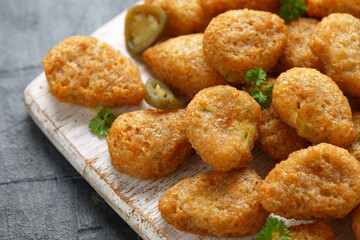 Crispy Jalapeno Popper with creamy cheese battered on white wooden board