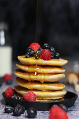 Pancake stack with blueberries and maple syrup drizzle 