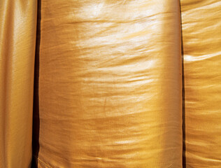 Background and detail of golden silk fabric texture. Design elements