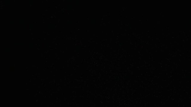 Flying up coconut chips on the black background. Slow motion
