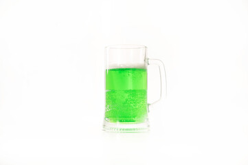 A pint of green beer for st patrick's day on a white background. Traditional Irish drink for a holiday. Copy space