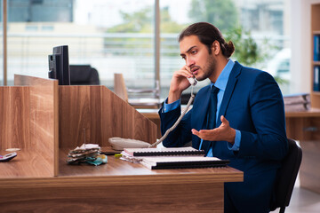 Young male employee working in the office