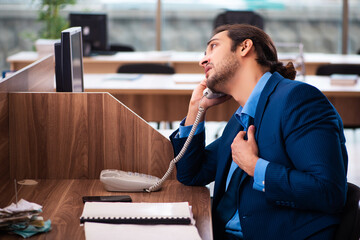 Young male employee working in the office