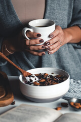 Fototapeta na wymiar cup of coffee in hands. The girl is having breakfast. beautiful manicure.