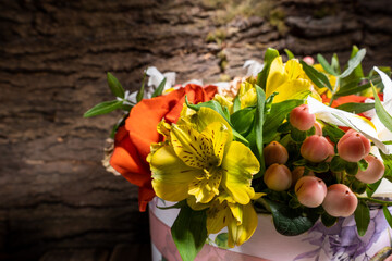 Basket of fresh flowers consisting of Rose Carnation Iris Alstroemeria Hypericum and pistachio