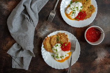 Pancakes with poached egg and red caviar