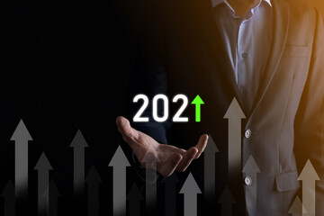 Business development to success and growing growth year 2021 concept.Plan business growth graph in year 2021 concept.Businessman plan and increase of positive indicators in his business