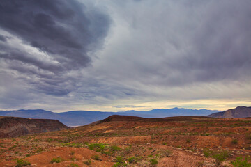 Scenic desert view with stormy sky and mountain range in the horizon, USA