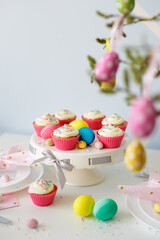 Easter sweets and decorations - cupcakes and colorful painted eggs