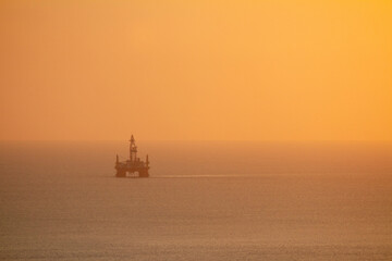 sea work rig oil sunset on the horizon