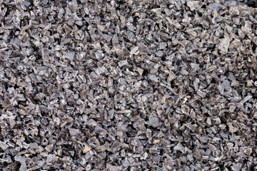 Recycling recyclable plastic, crushed pieces of polymer for reuse, industrial background concept of ecology, planet pollution and environmental protection