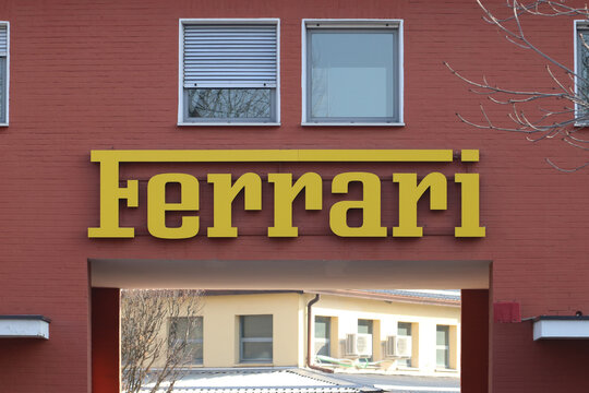 Maranello, Modena, Italy, February 2021 - Entrance of the original Ferrari Automobiles factory with the Ferrari logo in the foreground