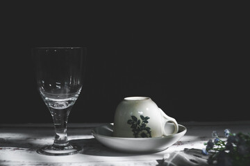 on the table there is a wine glass and cup Coffee, in accordance with the romantic mood and there is space for writing