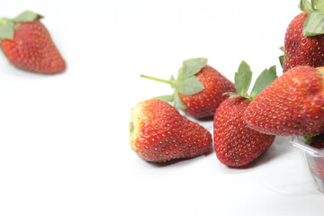 a bunch of creatively arranged strawberries with a white background. selective focus.