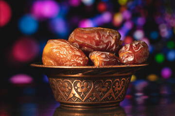 Ramadan concept with dried of dates on black background.