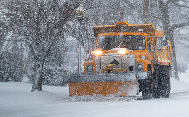 Yellow snow plow clearing roads suring peak of snow storm - obrazy, fototapety, plakaty