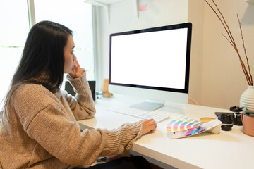 Cropped shot of two UI developers meeting on their project with paperwork and tablet on meeting...