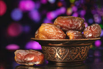 Ramadan concept with dried of dates on black background.
