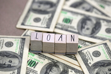 Word Loan with hundred dollar bills, business and finance concept, for mortgage or business background, copy space