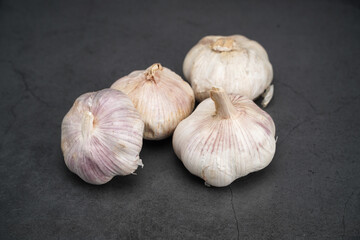 garlic on a table with a black background
