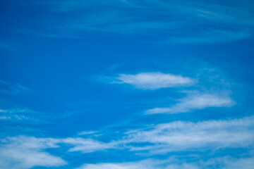 Naklejka na ściany i meble Dramatic clouds on blue sky. Horizontal landscape shot.