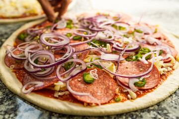 Pizaiolo Preparing Pizza in Restaurant with Fresh Ingredients. Chef at Work