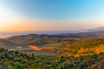 Naklejka premium sunrise over the hills and the sea in crimea on an autumn morning