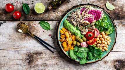 Buddha Bowl with Quinoa, Avocado, mushrooms, cucumber, chickpeas, spinach, tomatoes, avocado, vegetables salad. Clean eating, dieting, vegan food concept. top view
