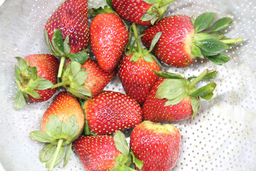 a bunch of creatively arranged strawberries with a white background. selective focus.