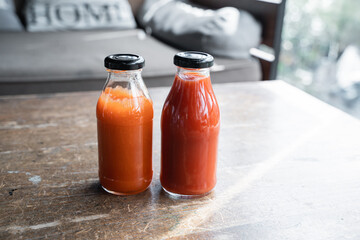 chili sauce and tomato ketchup in a glass bottle on the table