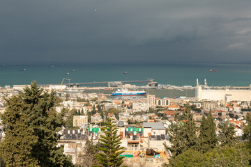 Fototapeta premium View on a rainy day from Mount Carmel to the downtown, the port and the Mediterranean Sea and Haifa city, in Israel.