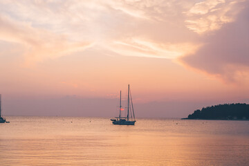 view of yacht in bay on sunset