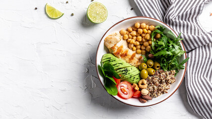 Buddha Bowl with Quinoa, Avocado, Roasted Chicken, Broccoli, chickpeas, spinach, tomatoes cherries, nuts, arugula. Clean eating, dieting food concept. top view