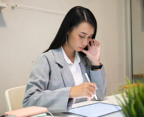 Cropped shot of two UI developers meeting on their project with paperwork and tablet on meeting...