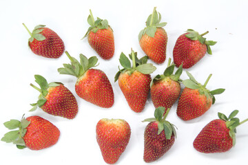 a bunch of creatively arranged strawberries with a white background. selective focus.