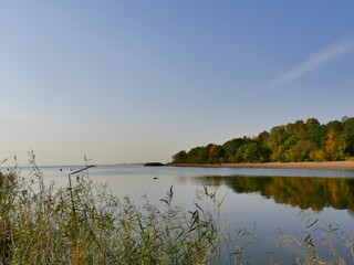 beautiful autumn landscape blue sky motley forest reflected in water quiet morning at river