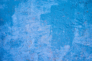 the texture of an old blue painted wall. rough background.