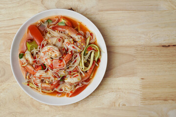 Spicy rice noodles salad with shrimp on white dish