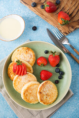 Homemade fried cheesecakes with condensed milk and berries