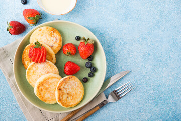 Homemade fried cheesecakes with condensed milk and berries